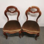 A pair of 19thC carved mahogany hall chairs.