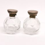 A pair of hallmarked silver topped cut crystal bottles, H. 9cm.