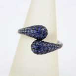 An 18ct white gold (stamped 750) ring set with graduated colour sapphires, ring size P.