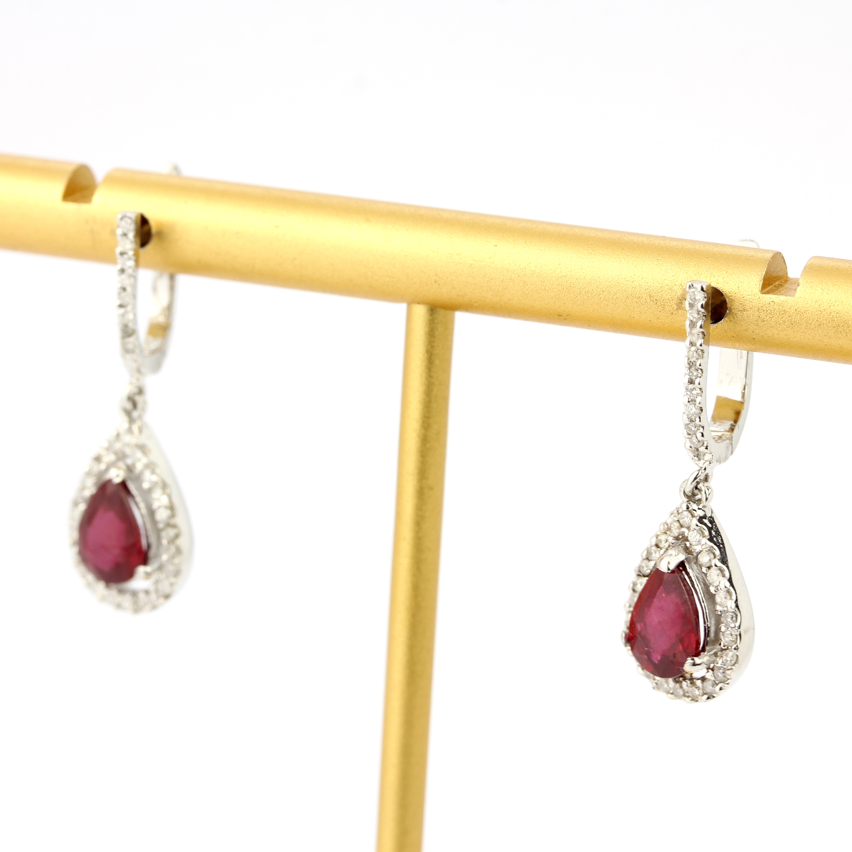 A pair of 18ct white gold drop earrings set with pear cut rubies and diamonds, L. 1.8cm. - Image 3 of 4