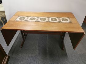 A 1970's tile topped teak drop leaf extending dining table, overall 255 x 87cm.
