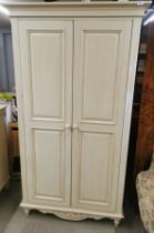 A matching painted wardrobe, size 107 x 193cm.