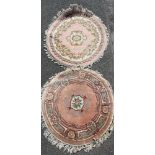 A pink ground washed wool Chinese rug together with a similar wool rug, largest dia. 125cm.