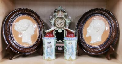A pair of glazed ceramic portrait plaques, H. 24cm. Together with a ceramic clock and a pair of