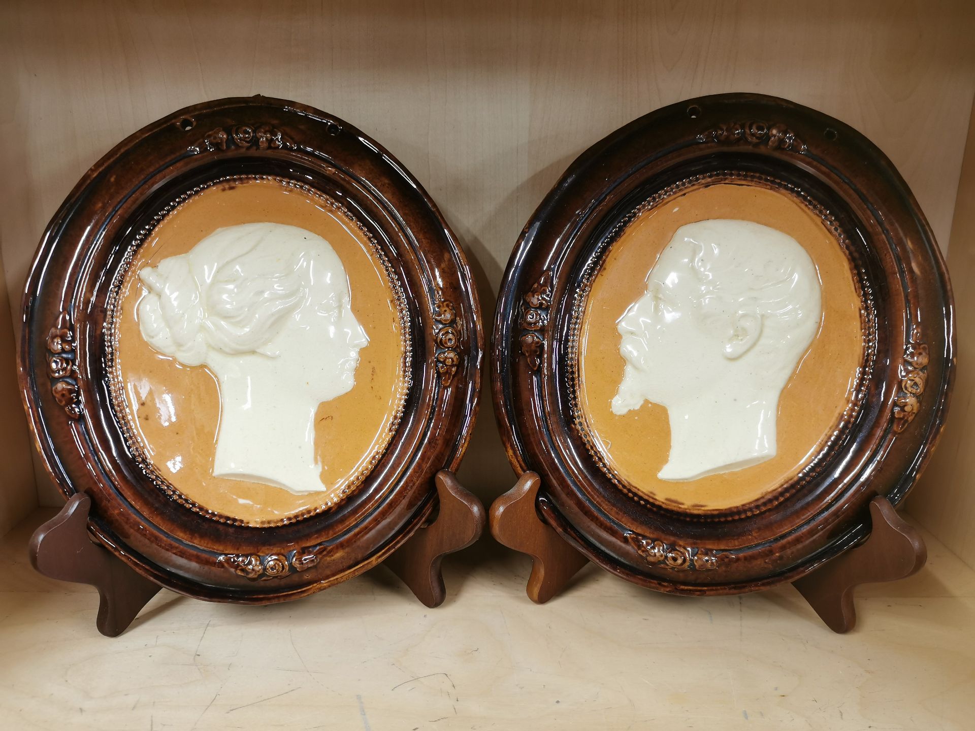 A pair of glazed ceramic portrait plaques, H. 24cm. Together with a ceramic clock and a pair of - Image 4 of 4