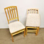 A pair of stylish folding beechwood chairs.