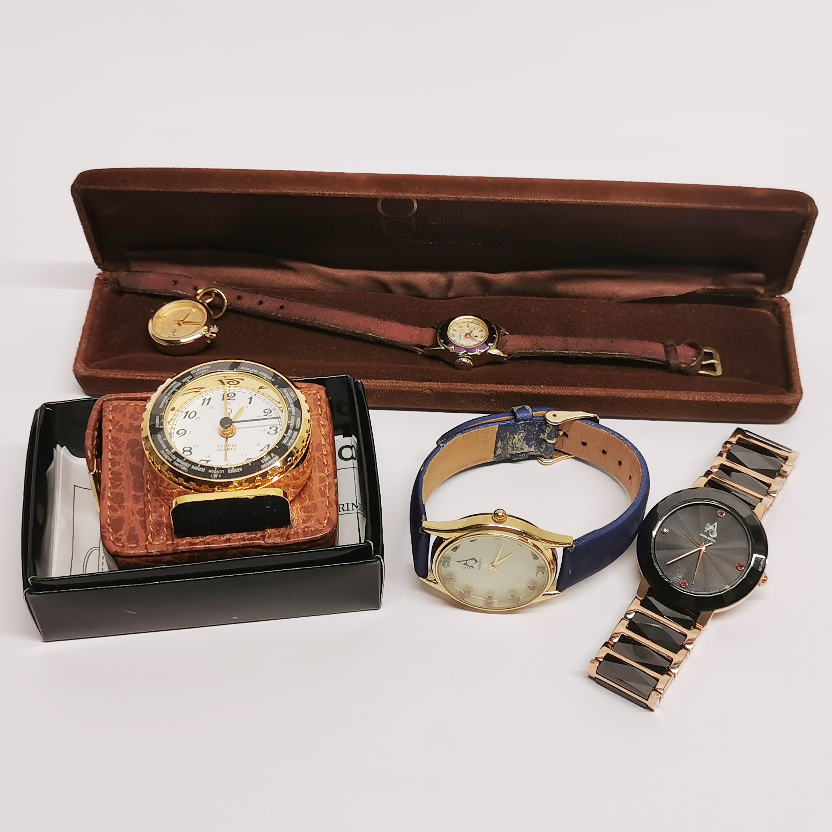 Four vintage watches including Anna Bella and a travelling clock.