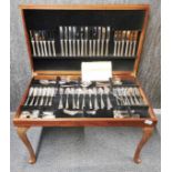 A leather topped coffee table cased silver plated cutlery set.