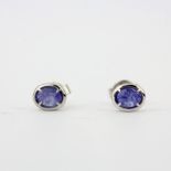 A pair of 18ct white gold earrings set with oval cut sapphires, L. 0.6cm.