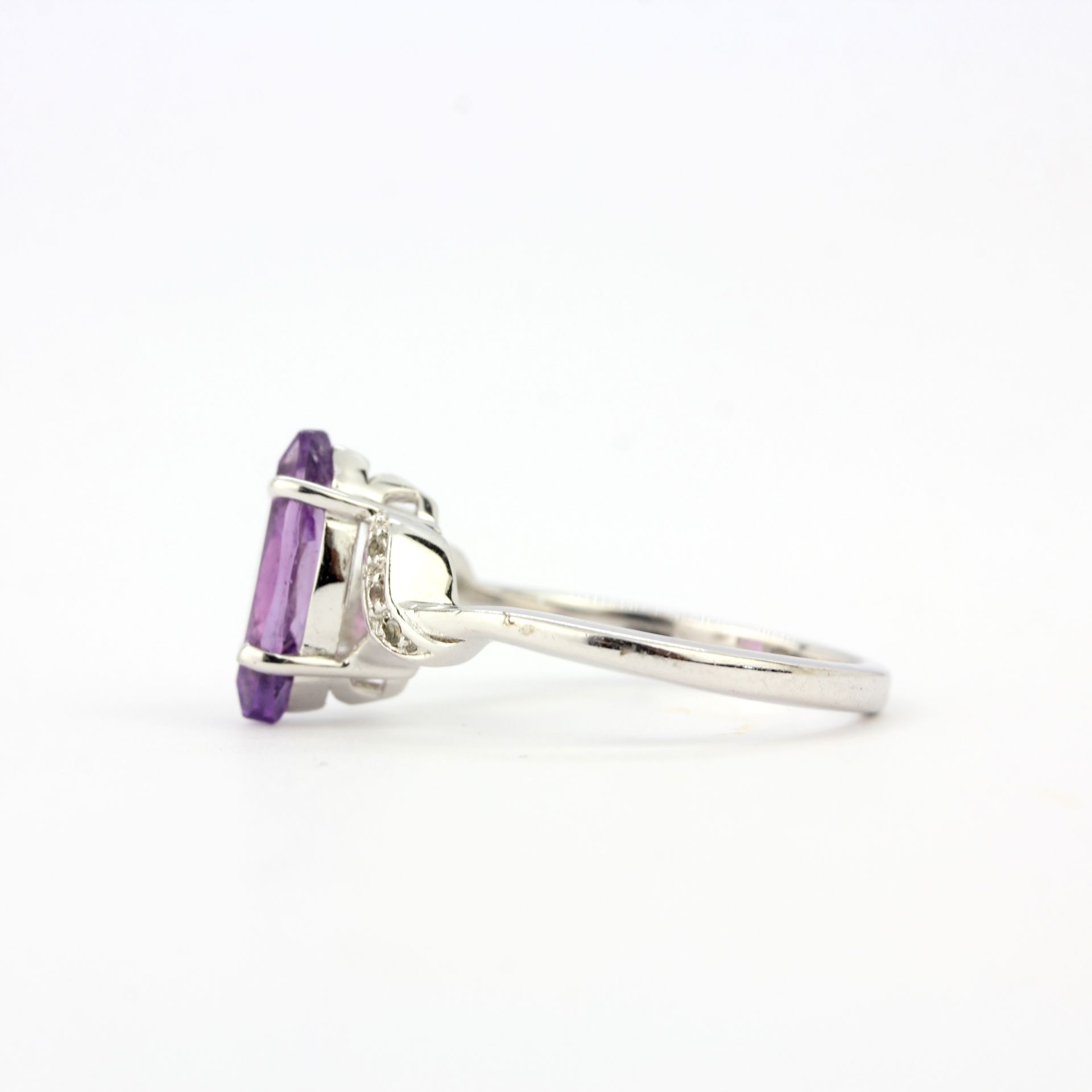 A 9ct white gold ring set with a marquise cut amethyst and diamonds, ring size N.5. - Image 2 of 3