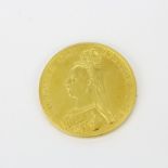 An 1887 commemorative Queen Victoria £5 gold coin.