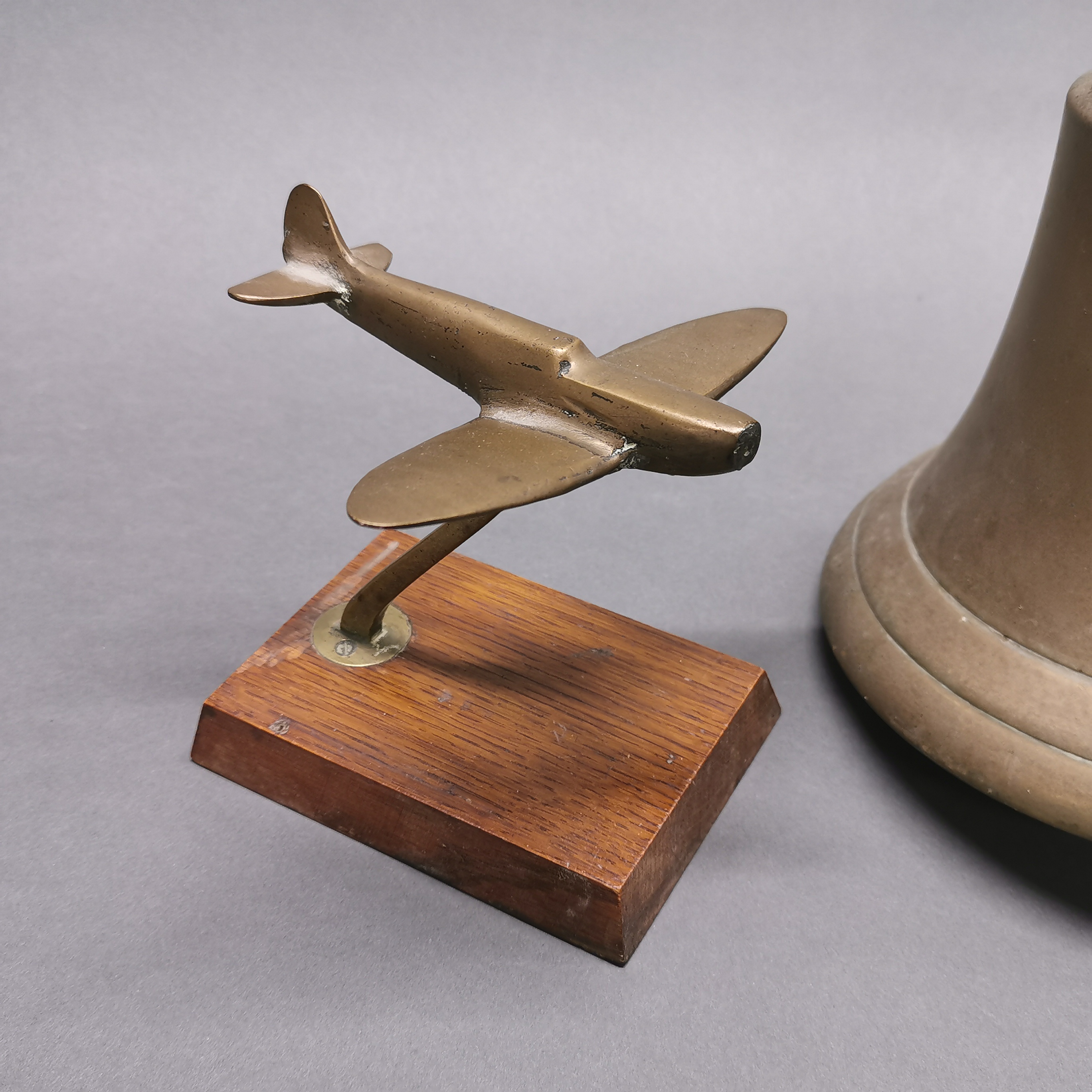 A wall mounted brass bell and a brass model of an aircraft, bell H. 22cm. - Image 2 of 4