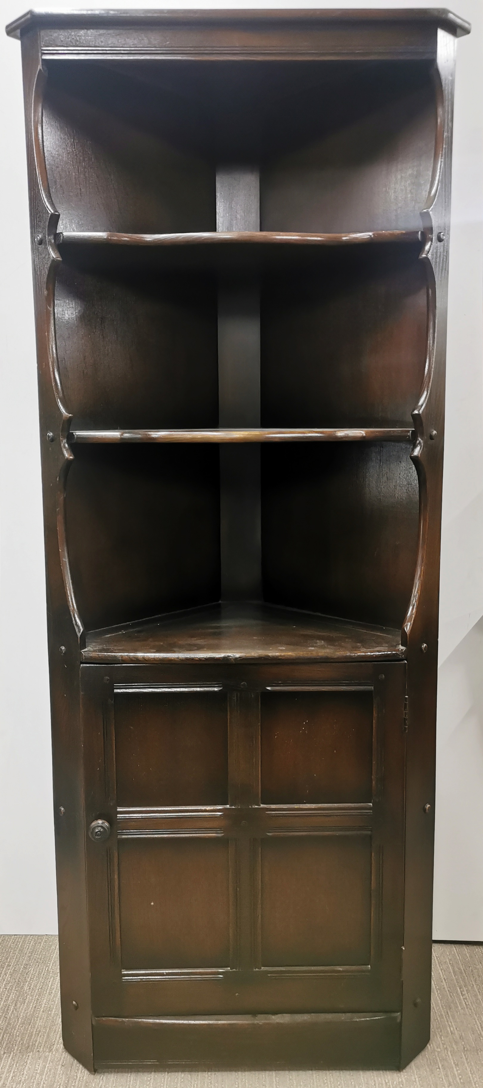 A mid 20thC Ercol corner cabinet, 184 x 76 x 42cm.
