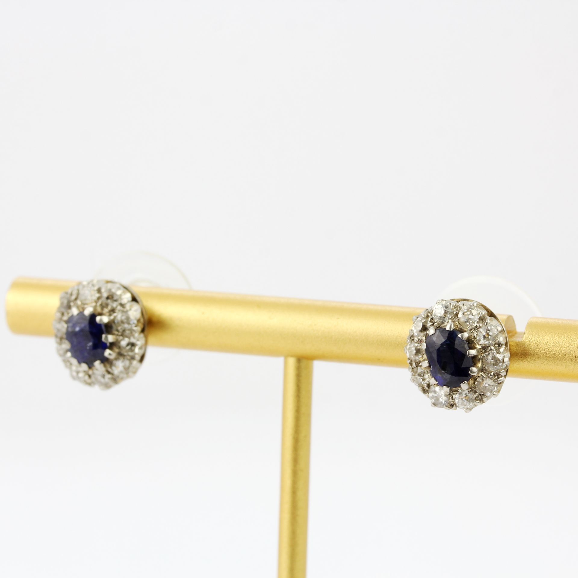 A pair of white metal (tested gold) diamond and sapphire cluster earrings, Dia. 1cm. With rubber - Image 2 of 3