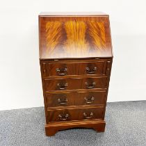 A flame mahogany veneered four drawer bureau, H. 100cm W. 51cm.