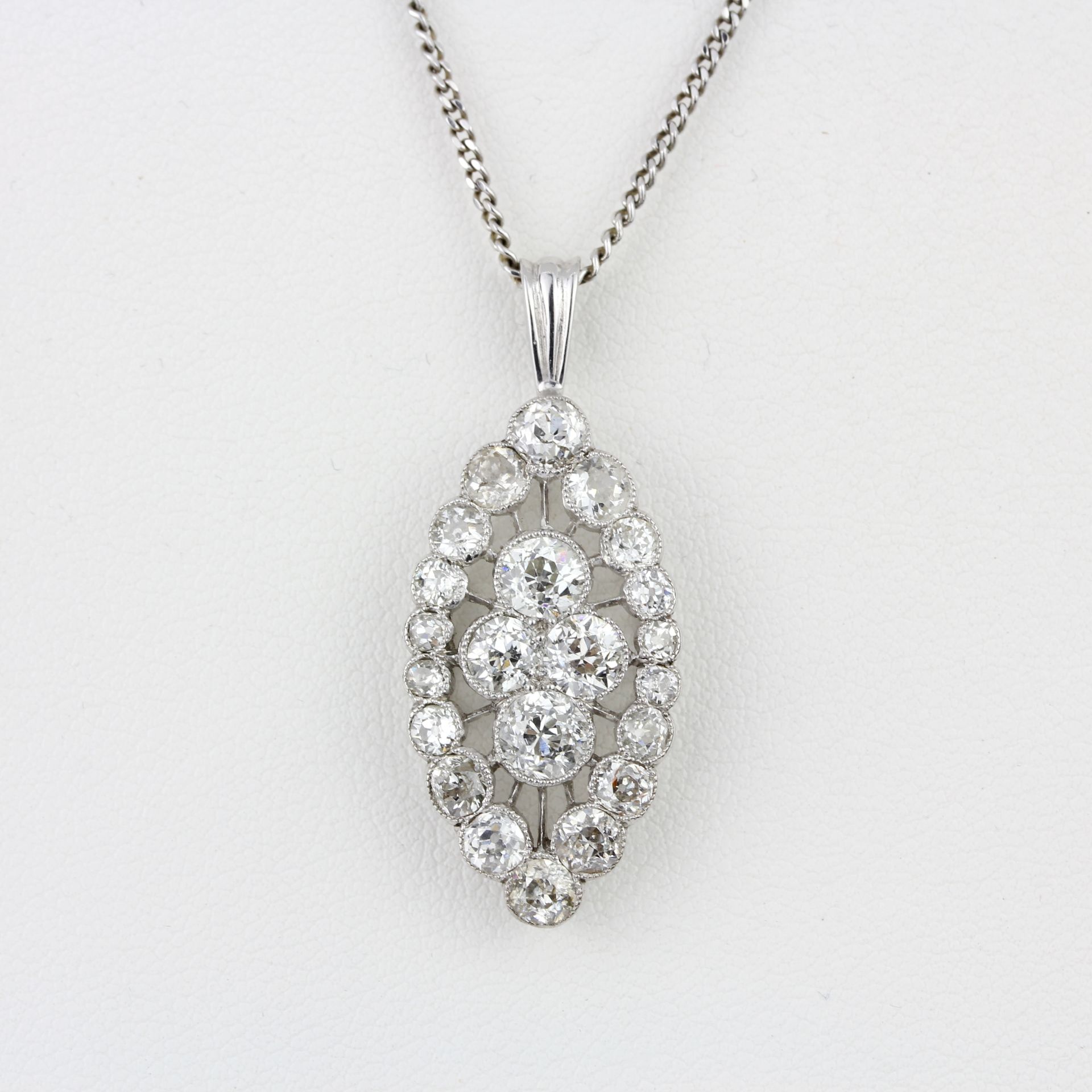 An 18ct white gold diamond set pendant and chain, set with old cut diamonds, approx. 2.65ct overall,