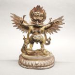 A Sino-Tibetan gilt bronze figure of Garuda, H. 29cm.