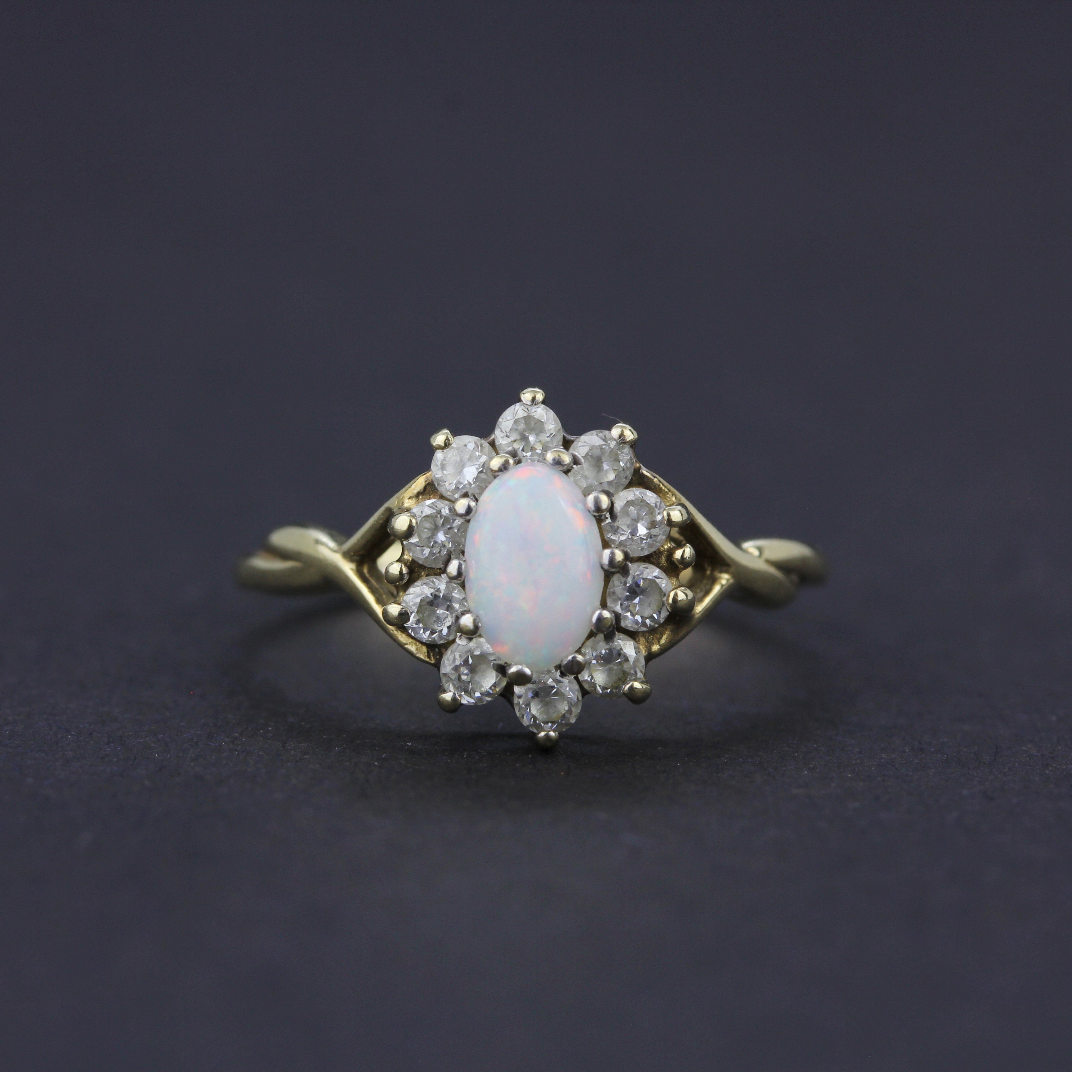 A 9ct yellow gold opal and white stone set cluster ring, ring size L.5.