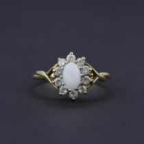 A 9ct yellow gold opal and white stone set cluster ring, ring size L.5.
