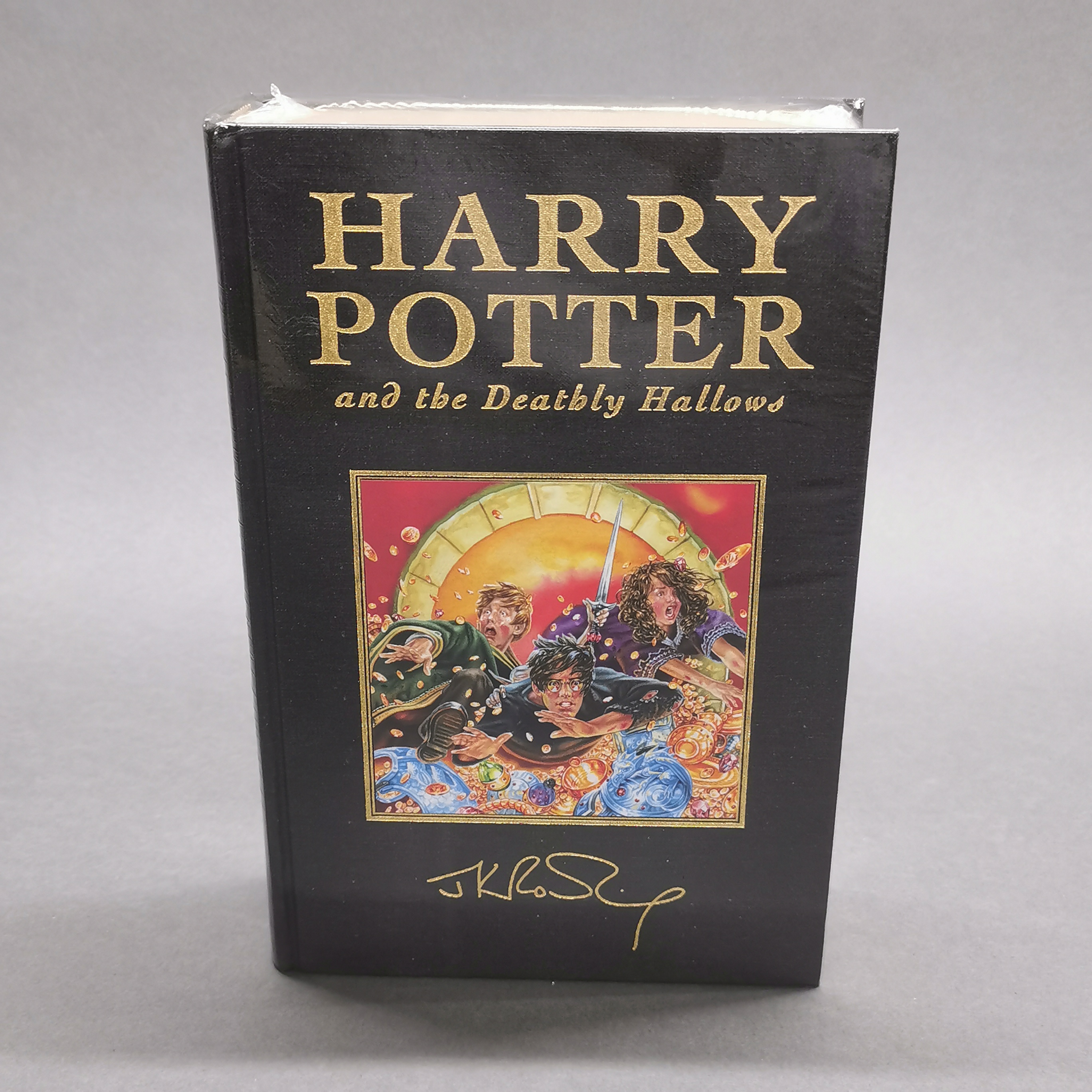 A first edition sealed hardback Harry Potter and the Deathly Hallows novel.