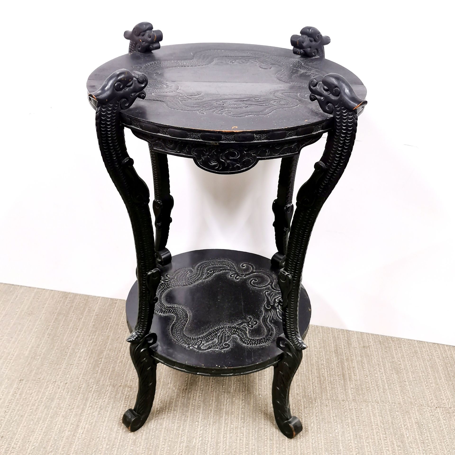 An oriental carved wooden side table decorated with dragons, W. 55cm, H. 77cm.