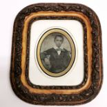 A 19thC framed tinted photographic portrait miniature of a boy, frame size 20 x 22cm.