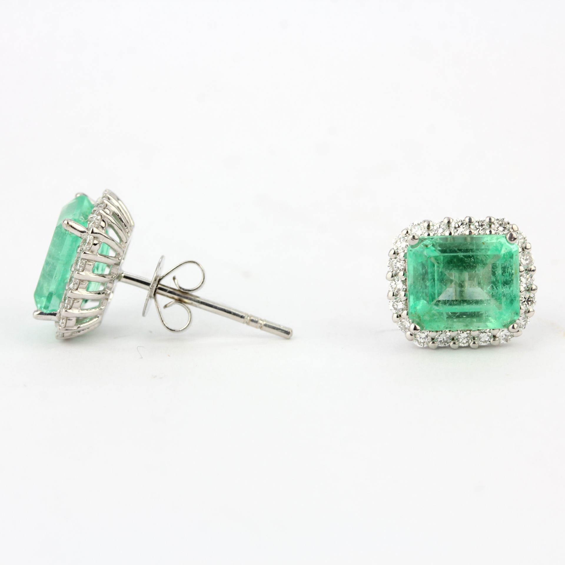 A pair of 18ct white gold earrings set with emerald cut emeralds and diamonds, L. 1.1cm. - Image 3 of 3