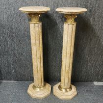 A pair of brass mounted marble columns, H. 100cm.