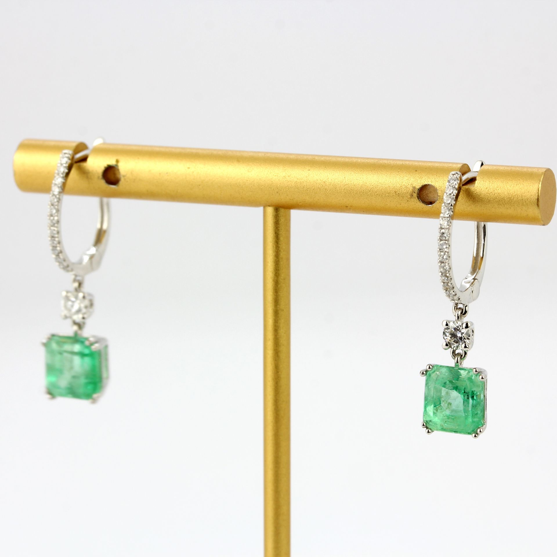 A pair of 18ct white gold drop earrings set with emerald cut emeralds and diamonds, L. 2.7cm. - Image 2 of 3