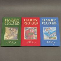 A first edition unsealed hardback Harry Potter and the Chamber of Secrets novel, together with two