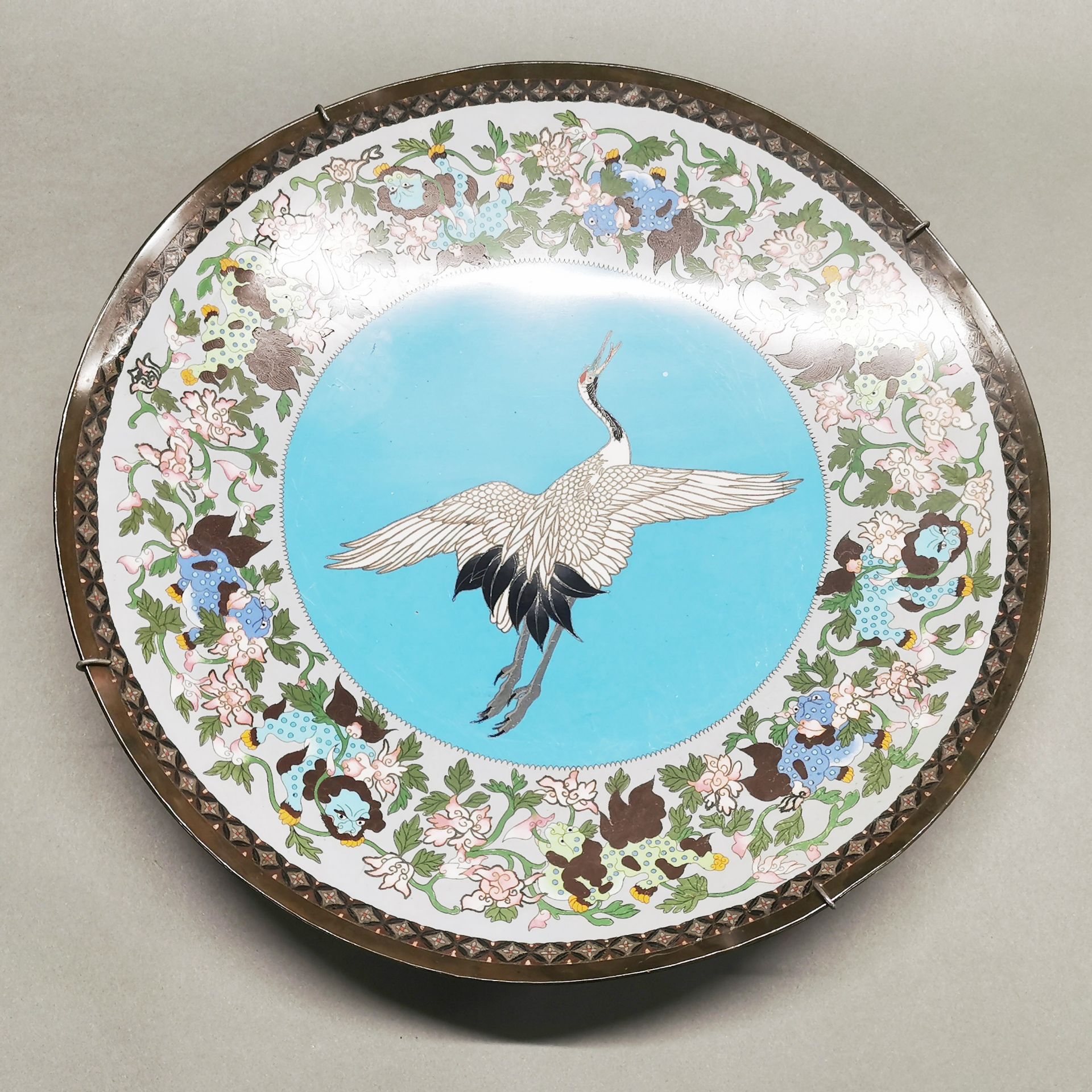 A 19th century Japanese cloisonne charger, Dia. 45cm. Slightly distorted and A/F to reverse.