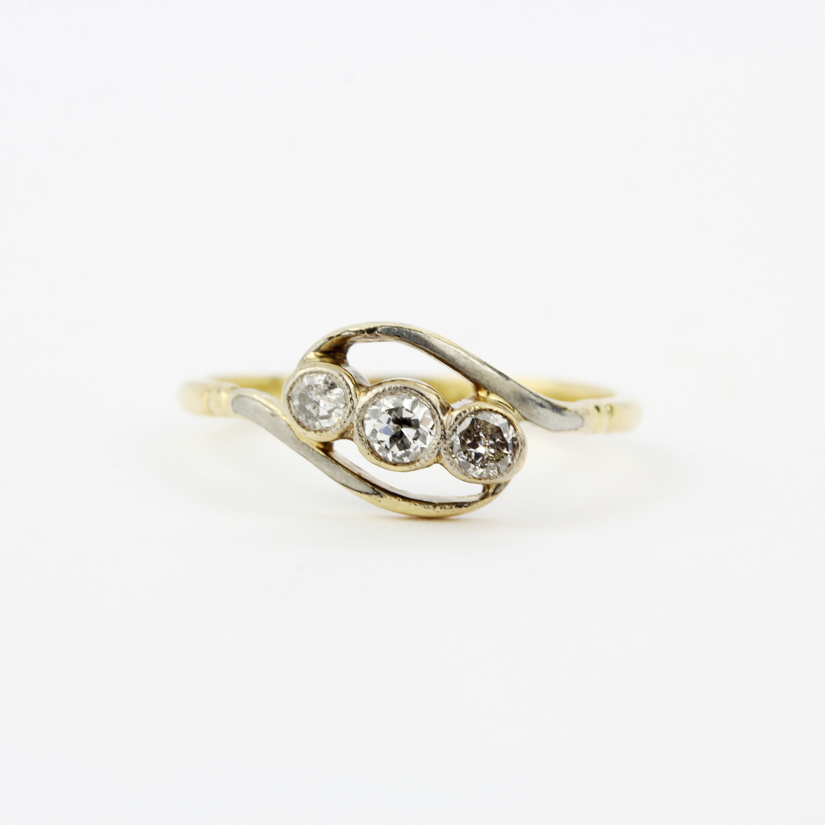 An early 20th century 18ct and platinum crossover ring set with three brilliant cut diamonds, ring - Image 2 of 3