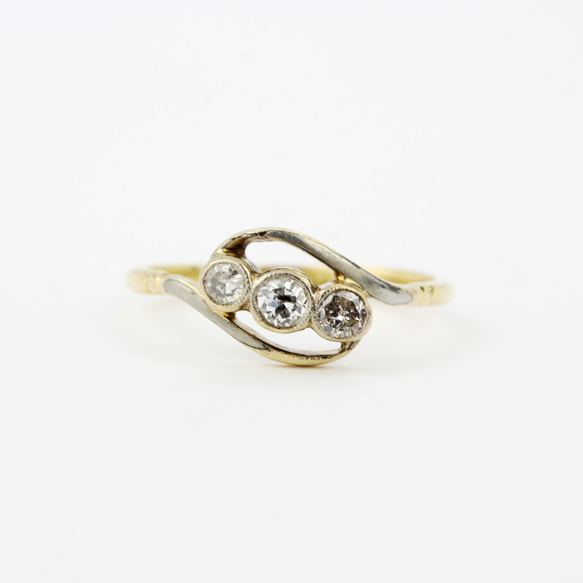 An early 20th century 18ct and platinum crossover ring set with three brilliant cut diamonds, ring - Image 2 of 3
