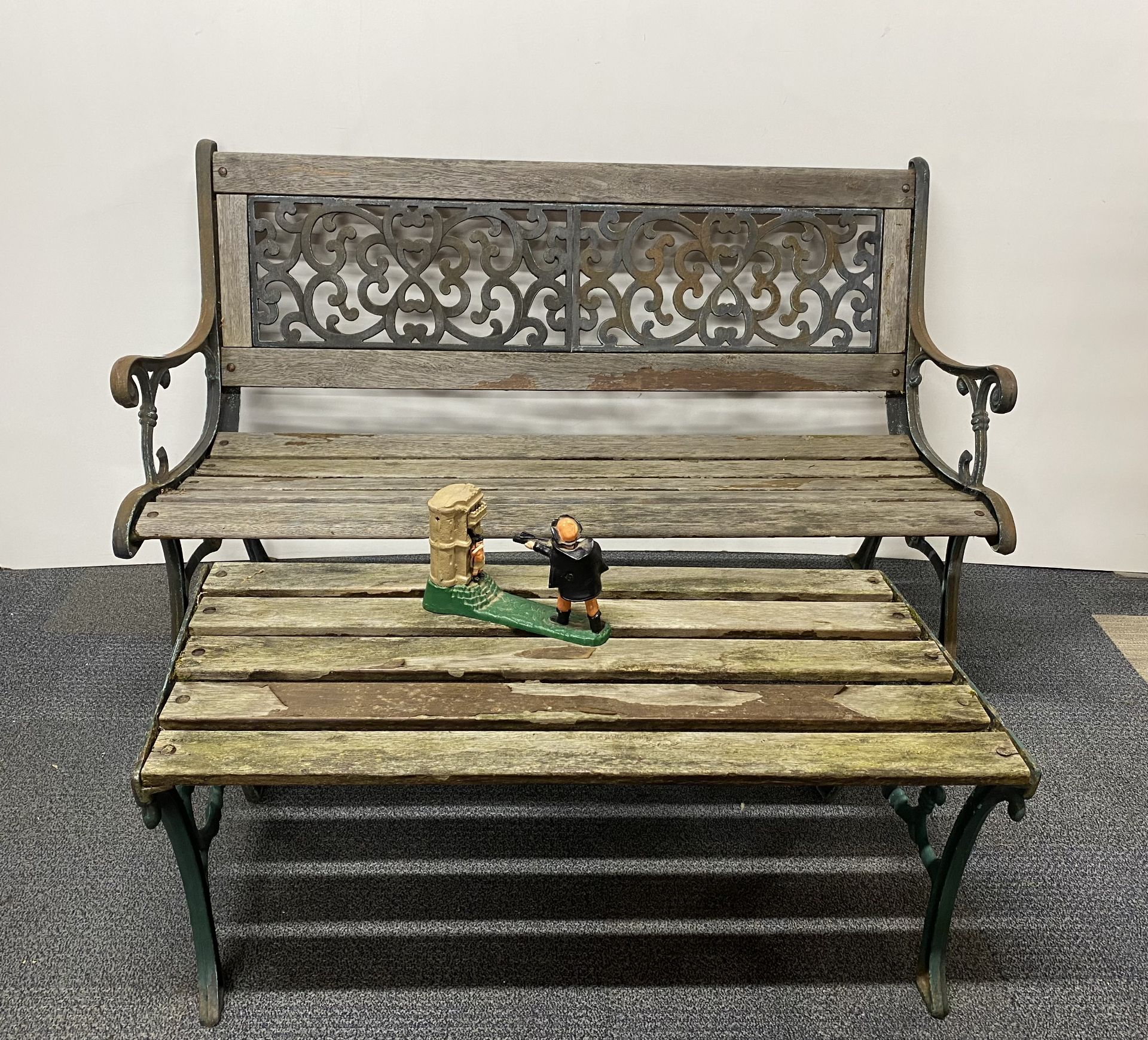 An old cast iron garden bench and table, bench W. 127cm, together with a cast iron William Tell