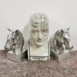 A pair of Art Deco style metal horse head book ends, H. 17cm. Together with a ceramic phrenology