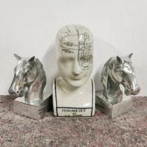 A pair of Art Deco style metal horse head book ends, H. 17cm. Together with a ceramic phrenology