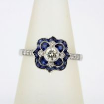 An 18ct white gold Art Deco style ring set with fancy cut sapphires and diamonds, ring size P.