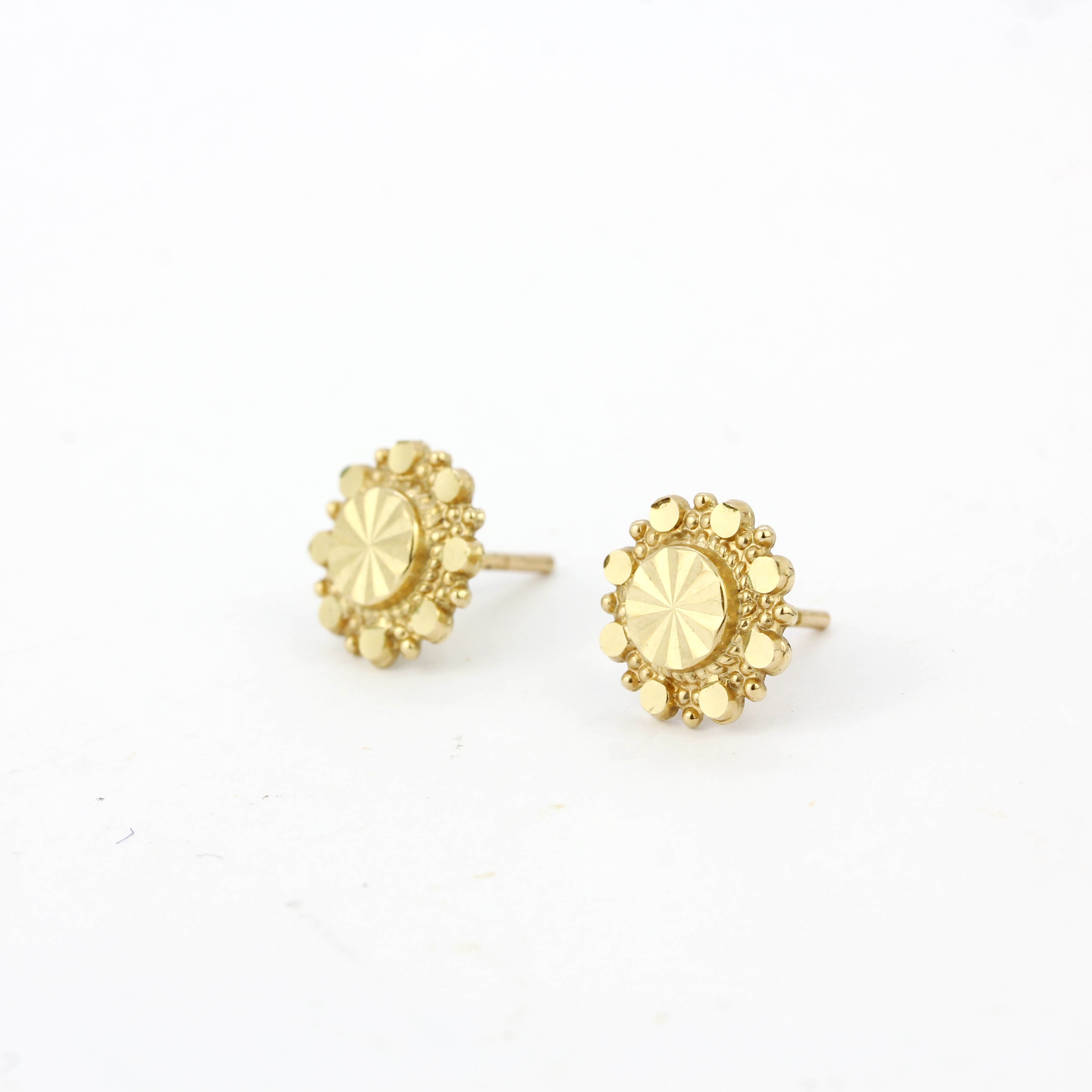 A pair of 9ct yellow gold stud earrings, Dia. 1cm.