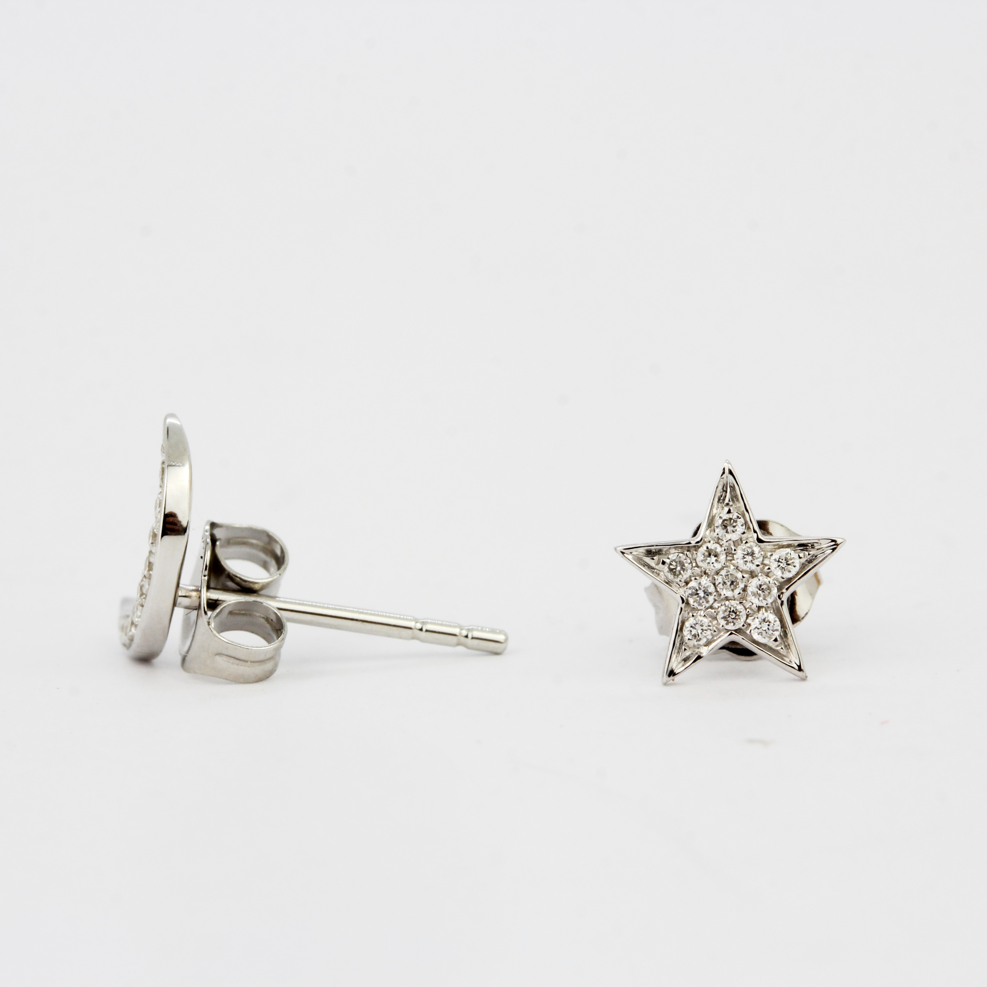 A pair of 18ct white gold diamond set star and moon shaped stud earrings, L. 0.9cm. - Image 3 of 3
