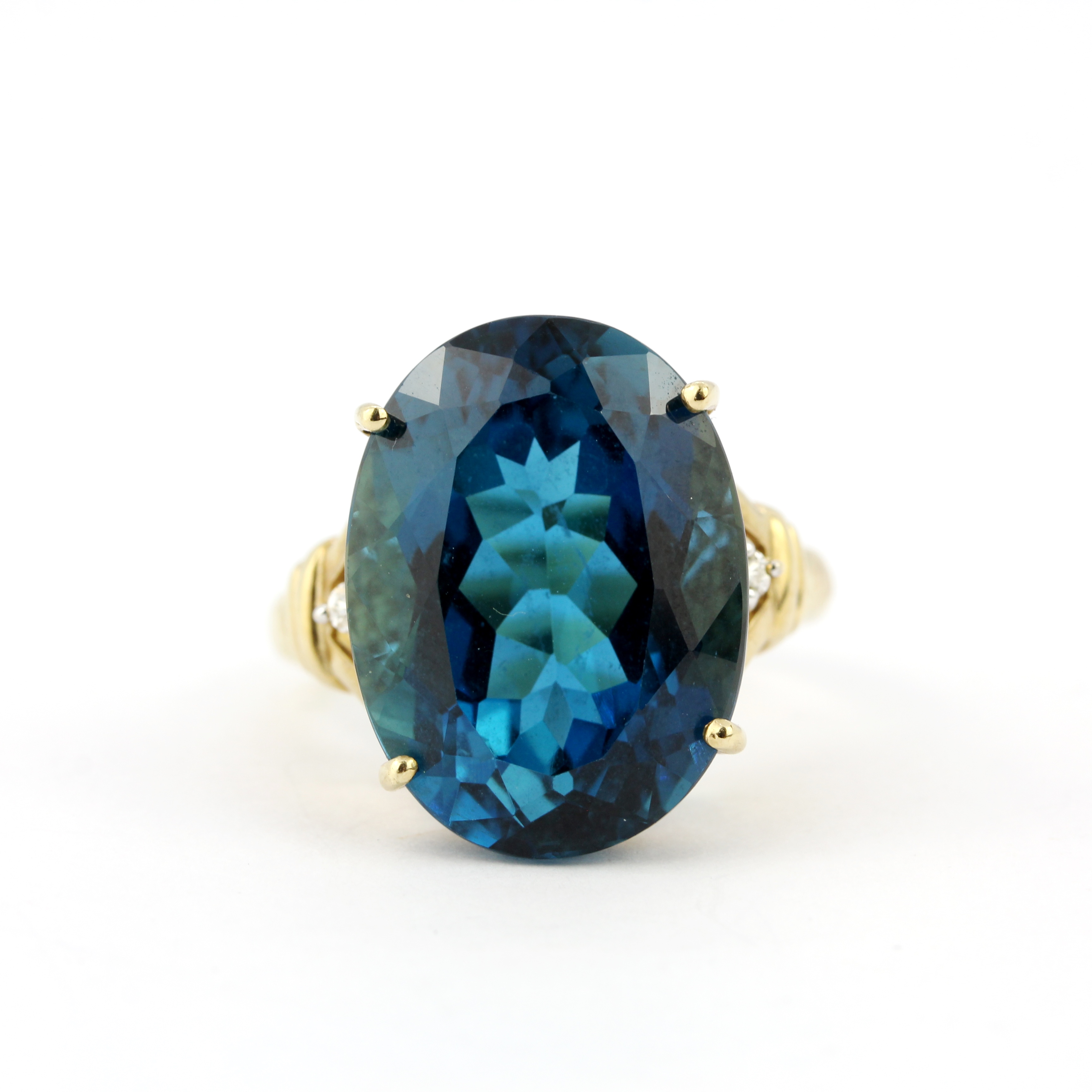 A 9ct yellow gold ring set with a large blue topaz and diamonds, ring size R.5.