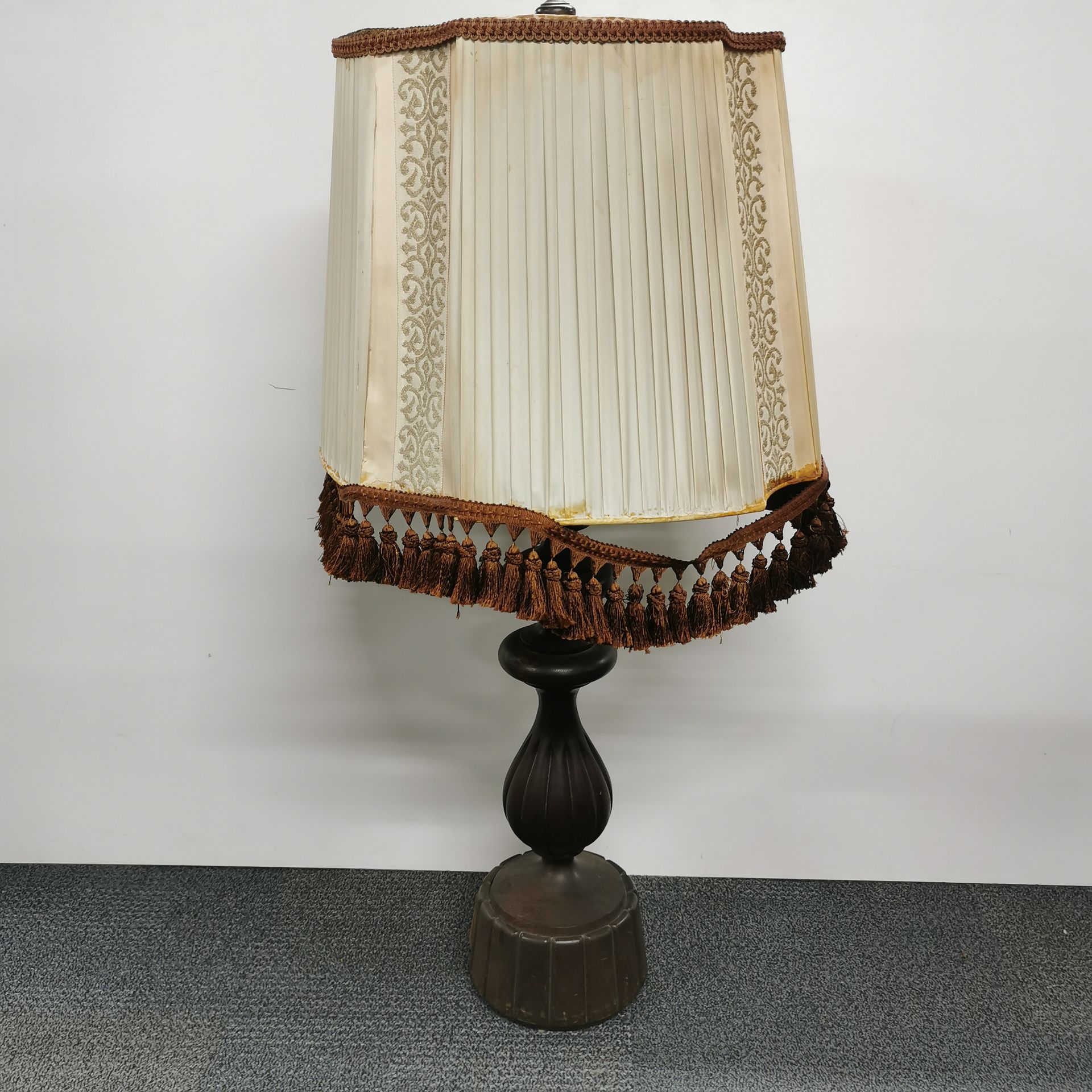 An impressive carved oak table lamp and shade, overall H. 110cm.