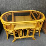 A vintage cane and glass conservatory/ kitchen set of table and two chairs, W. 110cm.