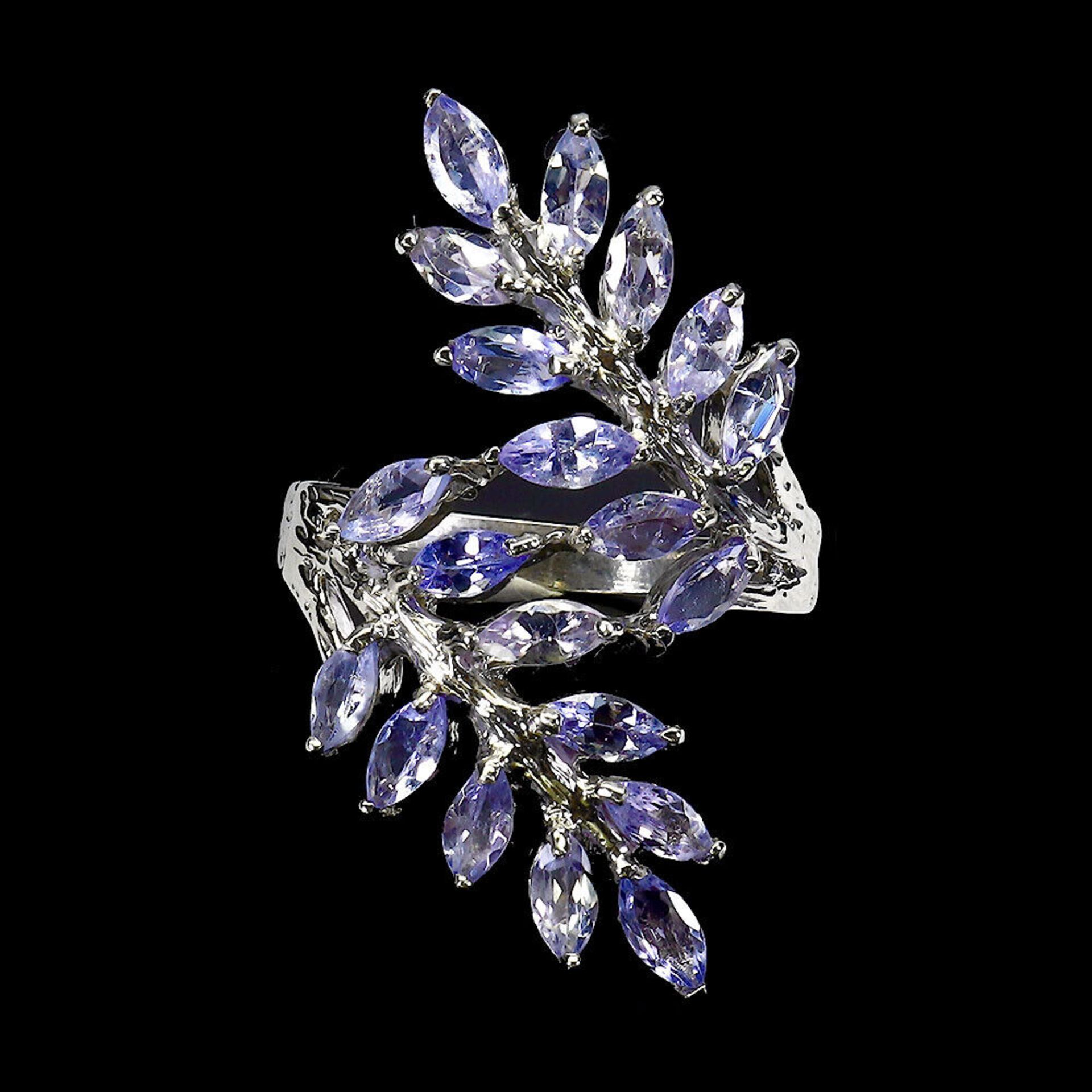 A 925 silver ring set with marquise cut tanzanites, ring size N.5.