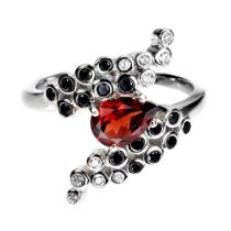 A 925 silver ring set with a pear cut garnet, onyx and white stones, ring size M.5.