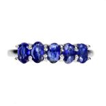 A 925 silver half eternity ring set with oval cut sapphires, ring size N.