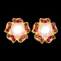 A pair of gold on 925 silver flower shaped earrings set with rubies and pearls, Dia. 2cm.