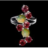 A 925 silver ring set with rubies and opals, ring size O.
