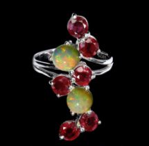 A 925 silver ring set with rubies and opals, ring size O.