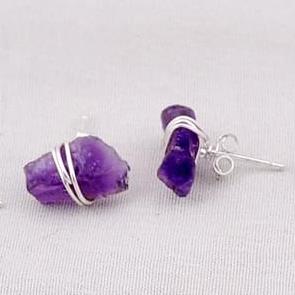 A pair of 925 silver rough amethyst set stud earrings.