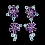 A pair of 925 silver flower shaped drop earrings set with amethysts and blue topaz, L. 3.4cm.